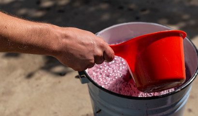 Wine making. The winemaker extracts the must from the container for further processing. Technology of wine production in Moldova. The  ancient folk tradition of grape processing. Harvest home.