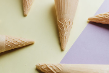 Composition of waffle cones on light background 