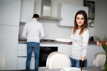 Couple setting the table before lunch