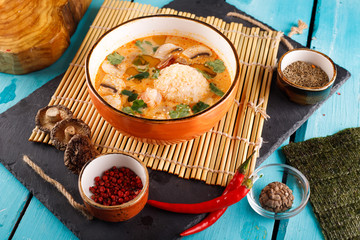 tomato soup with rice and vegetables in a white saucepan, close-up,