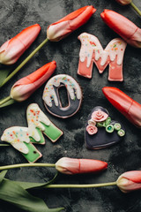 Beautiful red tulips and pink MOM lettering decoration, greeting card template