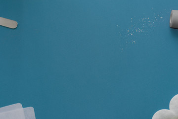 image of liquid sugar to remove hair. home care for depilation. hygiene beauty salon. spatula talcum wipes cotton pads on a blue background