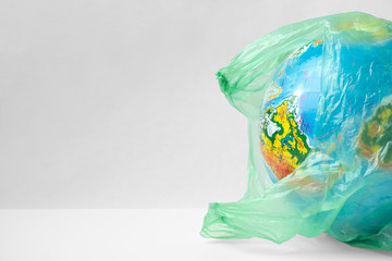 Earth planet in a plastic, eco no plastic concept, globe in plastic.