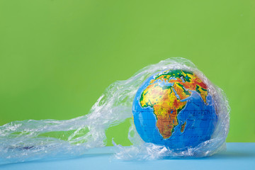 Earth planet in a plastic, eco no plastic concept, globe in plastic.