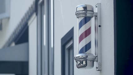 Spinning barber shop poll on city building