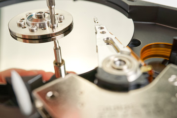 HDD. Inside of hard disk - magnetic disk with a reading head. close-up photo