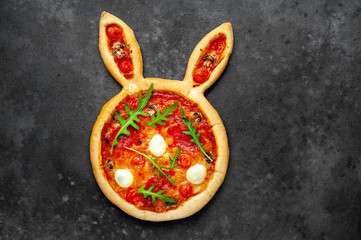  Easter pizza in the form of a rabbit with eggs on a stone background