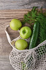 Zero waste, plastic-free and eco-friendly lifestyle and shopping. Cotton mesh bag with organic vegetables and fruits