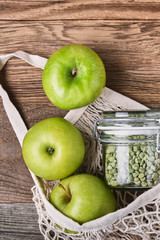 Zero waste, plastic-free and eco-friendly lifestyle and shopping. Cotton mesh bag, products in glass jar and fresh fruits