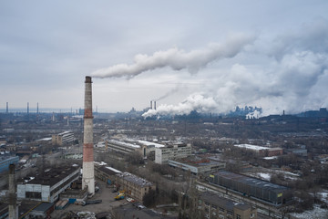Aerial view of factory pipes throwing hazardous emissions into the air.