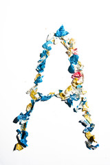 Letter smade with broken piece of chocolate wrapping papers, , typography concept for easter, , see the rest of the serie