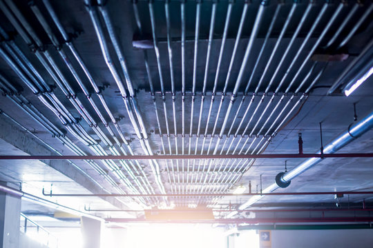 Blurry picture of electrical conduit and cabling. Blurry image for construction background. The rows of electrical conduit and signal cables in the parking building.