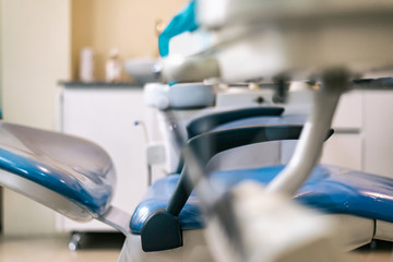 Fototapeta premium dentist's chair, side view, blue with white background and instrument table