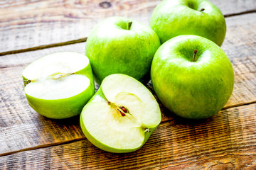 Healthy green food with apples on kitchen wooden background