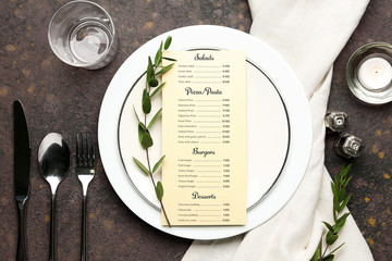 Beautiful table setting with menu on grey background