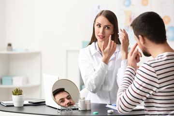 Ophthalmologist explaining patient how to use contact lenses
