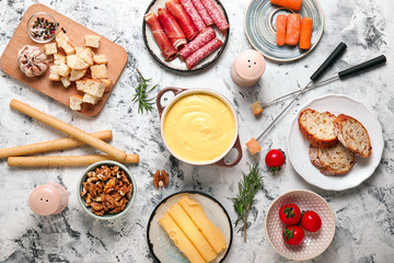 Fototapeta na wymiar Cheese fondue with snacks on white background