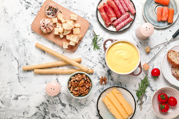 Cheese fondue with snacks on white background