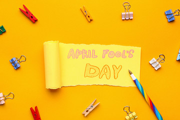 Paper sheet with text APRIL FOOL'S DAY on color background