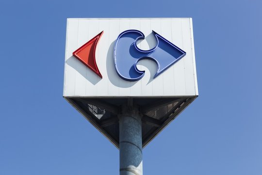 Macon, France - September 21, 2015: Carrefour sign on a pole. Carrefour is a french multinational retailer headquartered in France and it is one of the largest hypermarket chains in the world