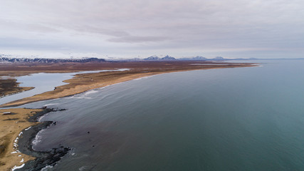 view of a beautiful sunset over the mountains on the shore of the Atlantic Ocean in Iceland