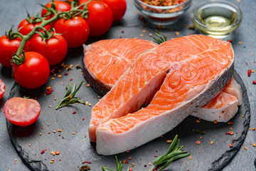 Raw salmon steaks on table