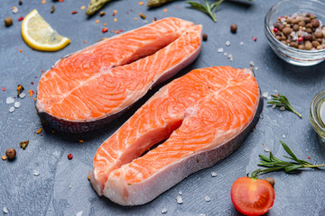 Raw salmon steaks on table