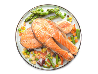 Plate with fried salmon and vegetables on white background