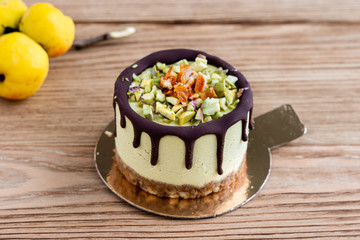Raw healthy dessert. Orange cake with chocolate. Wooden background