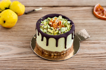 Raw healthy dessert. Orange cake with chocolate. Wooden background