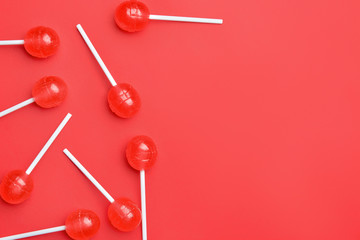 Tasty lollipops on color background