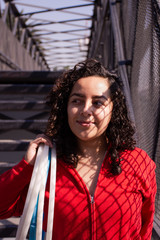 Portrait of a young woman with hula hoop rings on the street	