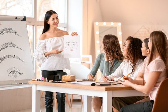 Young woman teaching students in makeup school