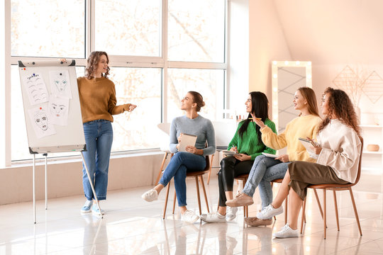 Young Woman Teaching Students In Makeup School