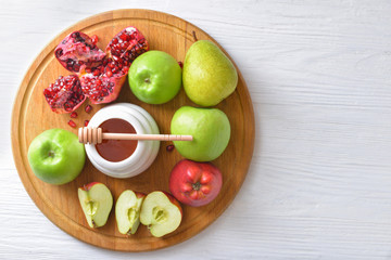 Sweet honey and fruits on table