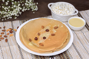 Homemade oat blini crepes pancakes with fresh cottage cheese, condensed milk. Healthy diet recipe...