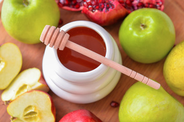 Sweet honey, apples and pomegranate on table