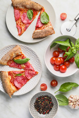 Slices of tasty pizza on white background