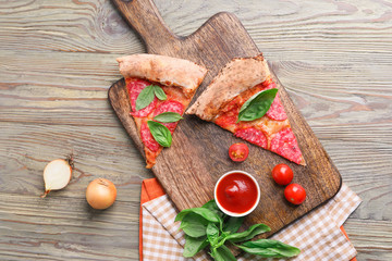 Slices of tasty pizza on wooden table