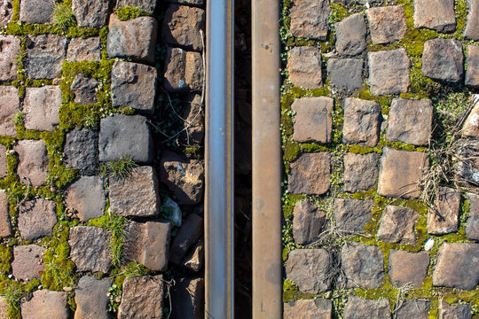 Two Parallel Railway Tracks on Stone Pavement Background
