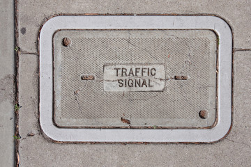 Close-up view of a concrete cover of a ground box for traffic light electricity