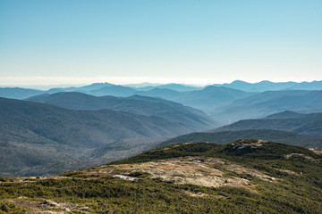 Fototapeta na wymiar Coniferous forest covered mountain ridge with a hiking trail on top. White Mountains, New Hampshire