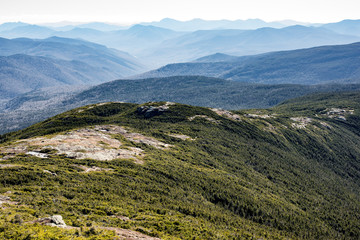 Coniferous forest covered mountain ridge with a hiking trail on top.