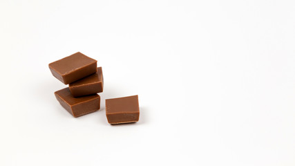 Macro photo of Chocolate bar. Broken pieces over white background