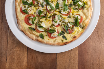 Pizza on the brown wooden table