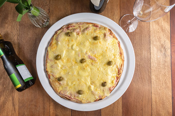 Pizza on the brown wooden table