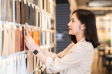 Architect or interior designer working with material sample board in showroom. Business of Real...