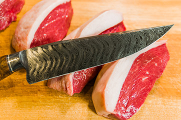 Beautiful photo of Picanha (top sirloin cap) cuts on a wooden cu