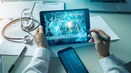 Cardiologist doctor analysis and checking data patient and  electronic medical record in tablet on digital modern virtual screen interface, Medical technology and network concept.
