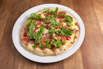 Pizza on the brown wooden table